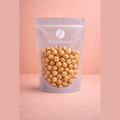 Nut House blanched lightly roasted hazelnuts in silver matte stand-up pouch with resealable top and transparent window showing pale golden-brown skinless nuts