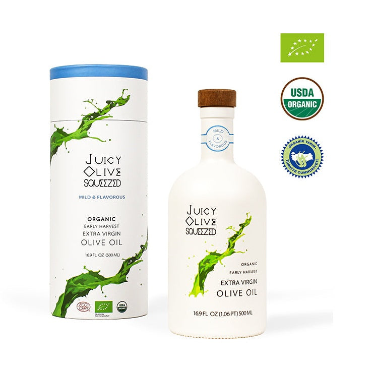 Juicy Olive Squeezed organic olive oil ceramic bottle with cork next to white tube packaging showing certifications