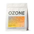 Ozone Seasonal Blend coffee beans in white matte resealable pouch with orange label showing red grape and green apple tasting notes