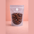 Nut House pitted dates in resealable pouch showing glossy dark brown sticky texture