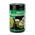 Sosa Matcha Green Tea Powder in black cylindrical container with vibrant lime-green powder and artisanal dessert balls