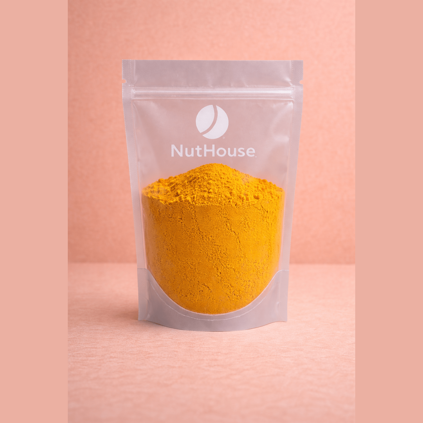Nut House ground turmeric in resealable pouch showing vibrant golden-yellow spice texture