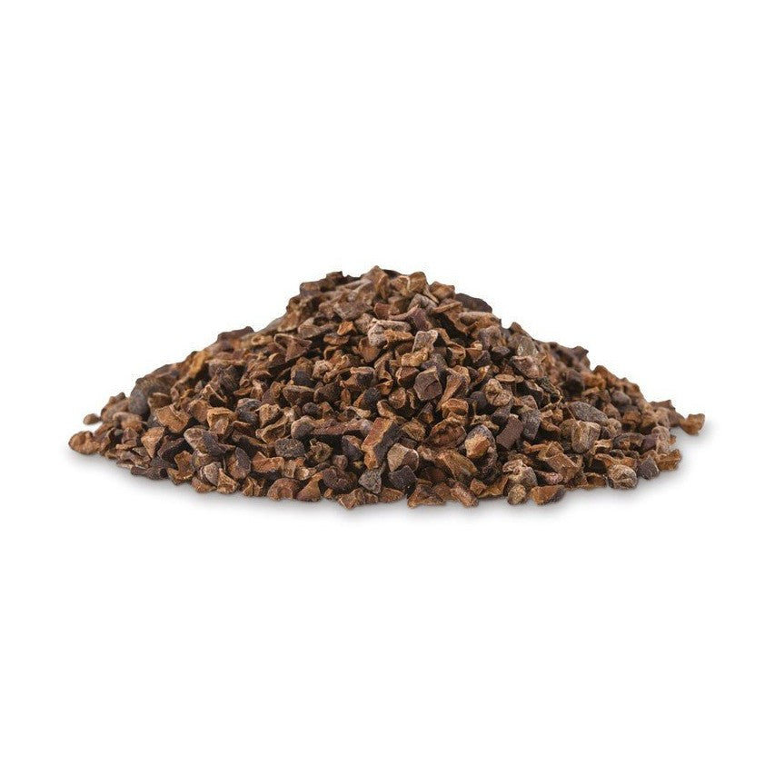 Close-up of Valrhona roasted dark brown cocoa nibs texture on white background