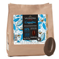 Valrhona Casaèbe dark chocolate packaging with a piece of chocolate on a white background
